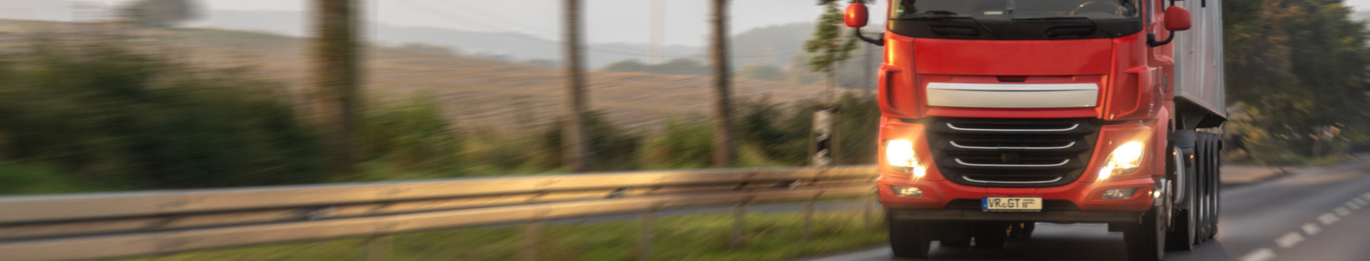 training-and-certifications/red-semi-rural-highway-with-headlights-morning-delivery